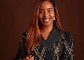 Portrait of a woman in black on a brown background